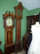 An unusually slender Oak cased long-case Clock, the case decorated in relief with bows and swags,