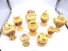 A quantity of Aynsley 'Orchard Gold' china including lidded vases, ginger jar, vases etc.