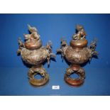 A pair of oriental bronze Incense Burners with scenes of birds and foliage,