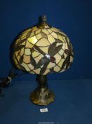 A contemporary Tiffany style Table Lamp with dragonfly decoration to the shade, 17 1/2'' tall,