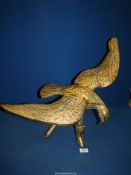 A brass figure of an Eagle on a branch, with wings extended, 25'' wide overall, 18 1/4'' tall.