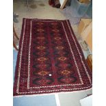 A red ground Persian Blunchi tribal rug, 205cm x 136cm.