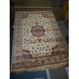 A gold ground Cashmere rug in floral medallion design, 170cm x 120cm.