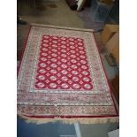 A red ground Cashmere Bohkara? design rug, 190cm x 140cm.