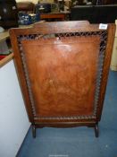 A fire screen with central leather panel of a sailing ship.