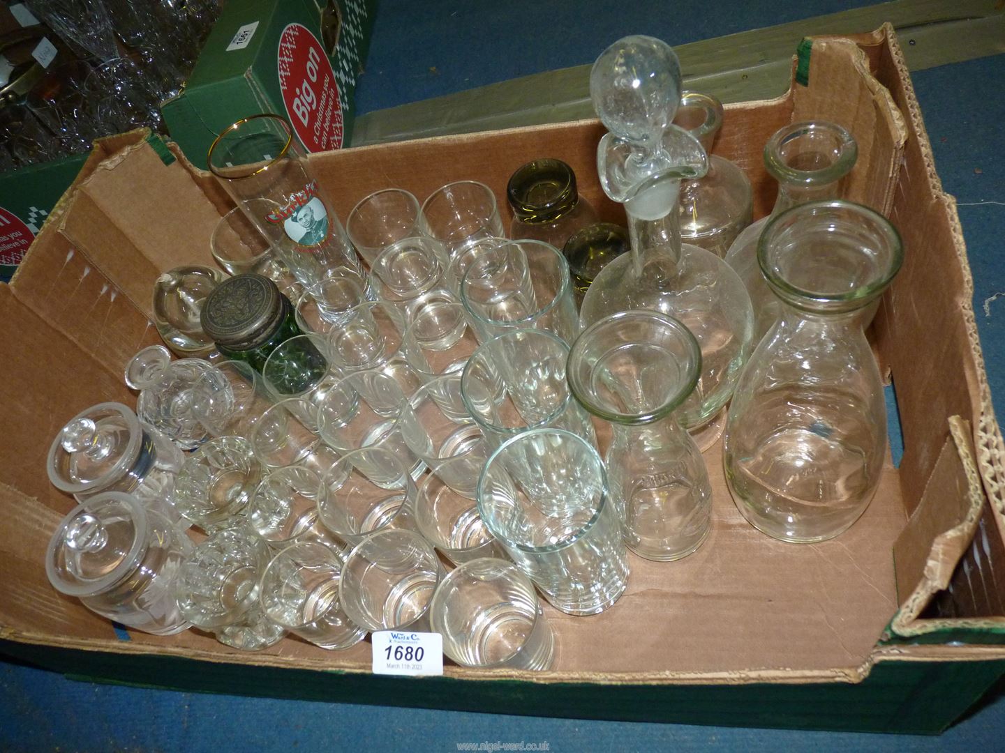 A quantity of miscellaneous glass including storage jars and lids, small miscellaneous tumblers,