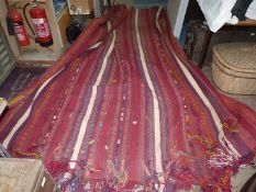 A large multi-coloured vertical line pattern Kelim carpet, with fringing, 11'4" x 8'.