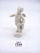 An early and well detailed Berlin white glazed figure of a winged cherub holding a tricorn hat in