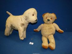 A well loved stuffed toy dog and an old Teddy Bear.