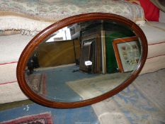 An oval rosewood inlaid Mirror.