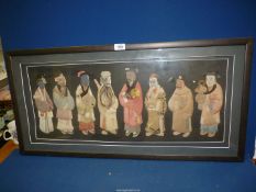 A framed Collage depicting eight oriental mortal figures depicted in fabric,
