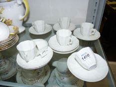 A Paris porcelain part coffee set comprising seven cups and eight saucers,