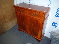 A cross banded Yewwood finished contemporary Sideboard/Cabinet of small dimensions having a pair of
