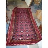A Persian Blunchi nomadic full pile rug, 268cm x 138cm.