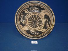 A Thai Kalong pottery dish with crow's foot decoration in iron black, 10 5/8" diameter.