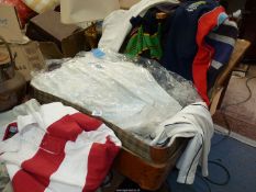 A quantity of Rugby shirts and Cricket whites in large sizes, in suitcase.
