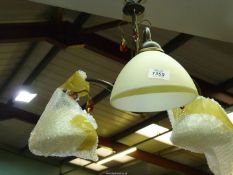 A continental triple fitting ceiling light with cream glass shades and amber coloured glass