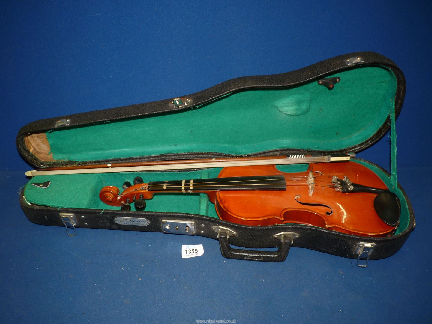 A cased Violin, made in China, 20 11/16'' long, the body 13'' long, together with a bow and resin.