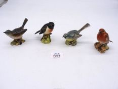 Four Beswick birds including Whitethroat, Grey Wagtail, Stonechat and Robin, all approx. 3" tall.