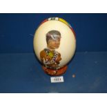 An Ostrich Egg painted with a picture of an African Lady with beads.