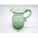 A hand blown green glass jug,