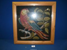 A woolwork tapestry of a Parrot, framed, 19'' x 20''.