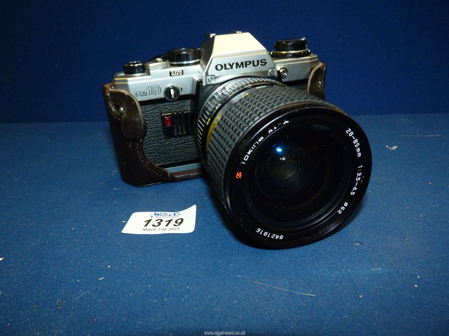 An Olympus OM10 35mm SLR Camera together with a Tokina AT-X 28-85mm f/3.5-4.5 zoom lens.