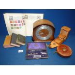 A mantle clock (with key), a boat cigarette box, part old compass set, leather bound tape measure,