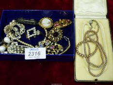 A small quantity of Costume Jewellery including brooches, earrings, simulated pearl necklace etc.