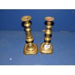 A pair of brass Candlesticks with pushers, some dings.