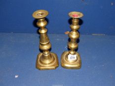 A pair of brass Candlesticks with pushers, some dings.