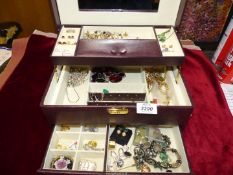 A brown leatherette jewellery box with contents including some silver items.
