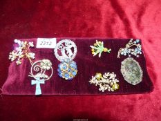 A pad of Costume Brooches including a blue stone cross