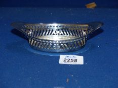 A silver Bonbon dish with sloping slat pierced sides and bell shape border above, Sheffield 1911,