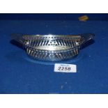 A silver Bonbon dish with sloping slat pierced sides and bell shape border above, Sheffield 1911,