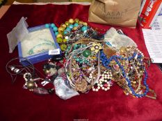 A large quantity of mostly chunky beaded necklaces, chains, brooches, etc.