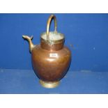 A large copper and brass pouring vessel with stylised spout, 17'' tall.