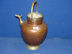 A large copper and brass pouring vessel with stylised spout, 17'' tall.