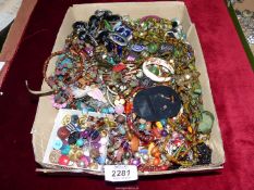 A box of costume jewellery including beads.