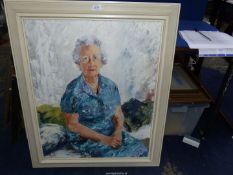 A large framed impasto portrait of an older lady in a blue dress sitting with her hands crossed on