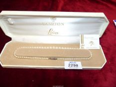 A Lotus simulated pearl necklace in box