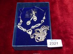 An Art Deco silver paste set with necklace and drop earrings and an Art Deco brooch.