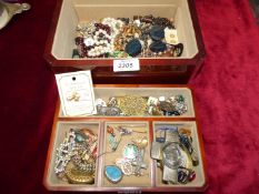 A jewellery box containing miscellaneous jewellery including bracelets, clip on earrings, beads etc.