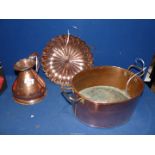 A large copper oval pan, quart jug and platter.