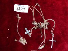 A silver Dragonfly pendant and chain, an aqua stone cross pendant and a silver cross and chain.