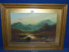 A framed and mounted oil painting of a river landscape with rolling hills in the distance,