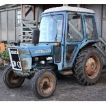 A Ford 3600 three cylinder Diesel-engined farm Tractor having a bubble cab,