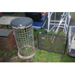 Wrought iron spark guard and galvanised mesh waste paper bin.