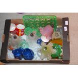 Box of coloured glass, lamp shades, mugs etc.