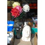 Artificial vase of flowers and a bust.